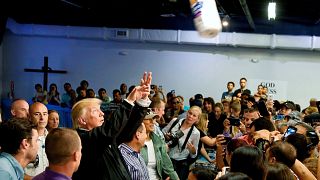 Image: President Trump throws a roll of paper towels to residents gathered