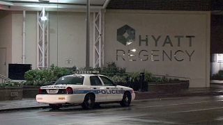 Image: A police car sits outside the Hyatt Regency hotel in Houston