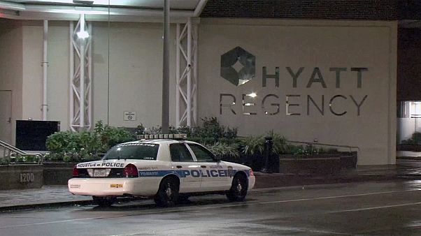 Image: A police car sits outside the Hyatt Regency hotel in Houston Image: A police car sits outside the Hyatt Regency hotel in Houston