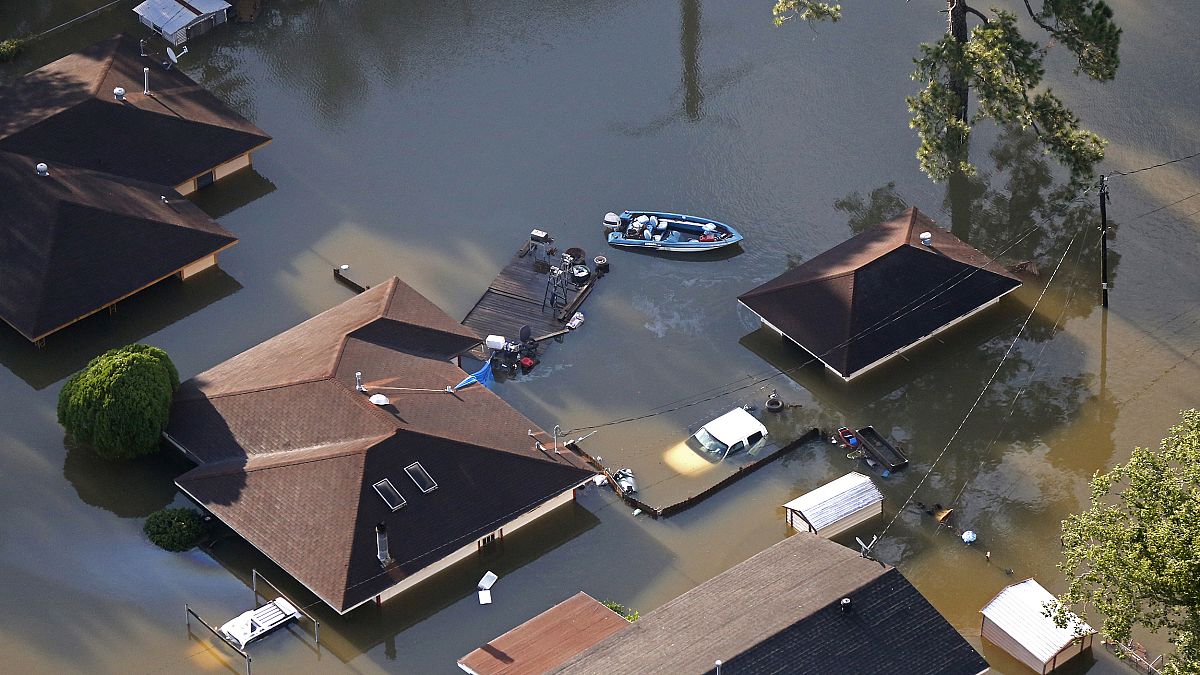 Image: A boat sits near flooded homes in the aftermath of Tropical Storm Ha