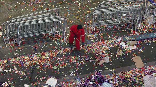 Image: A member of the cleanup crew sweeps confetti in New York's Times Squ Image: A member of the cleanup crew sweeps confetti in New York's Times Squ