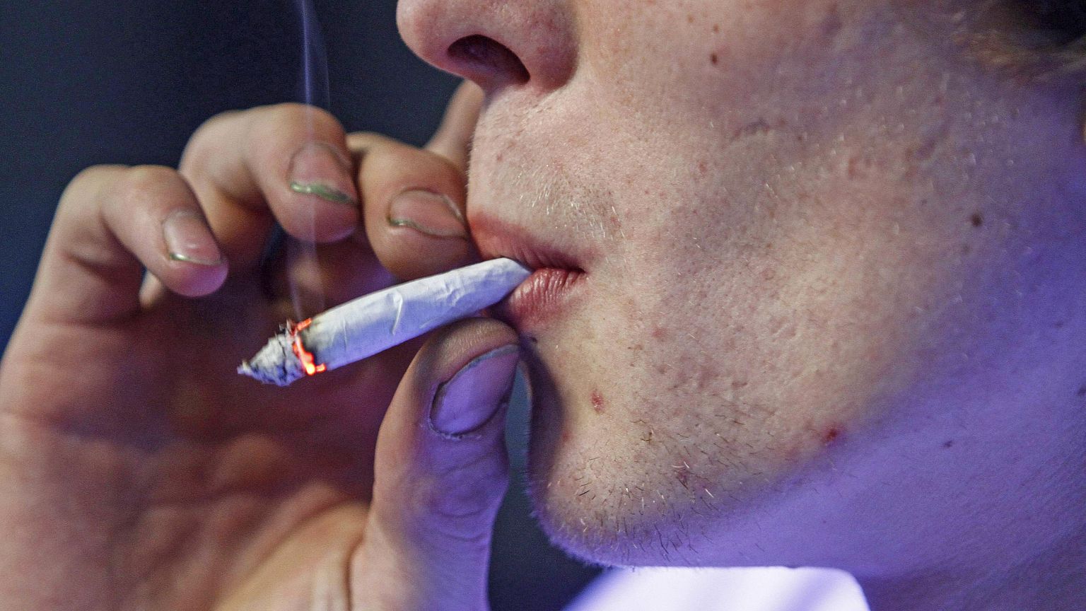 Image: Russell Diercks smokes a half marijuana and tobacco joint inside of 
