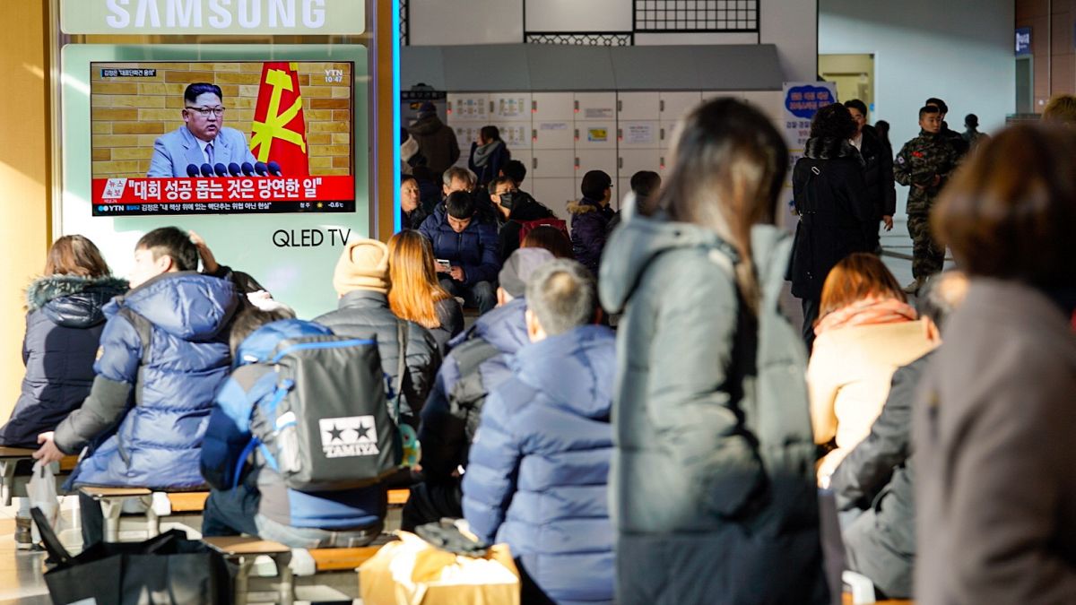 Image: South Koreans in Seoul's main train station watch Kim Jong Un addres