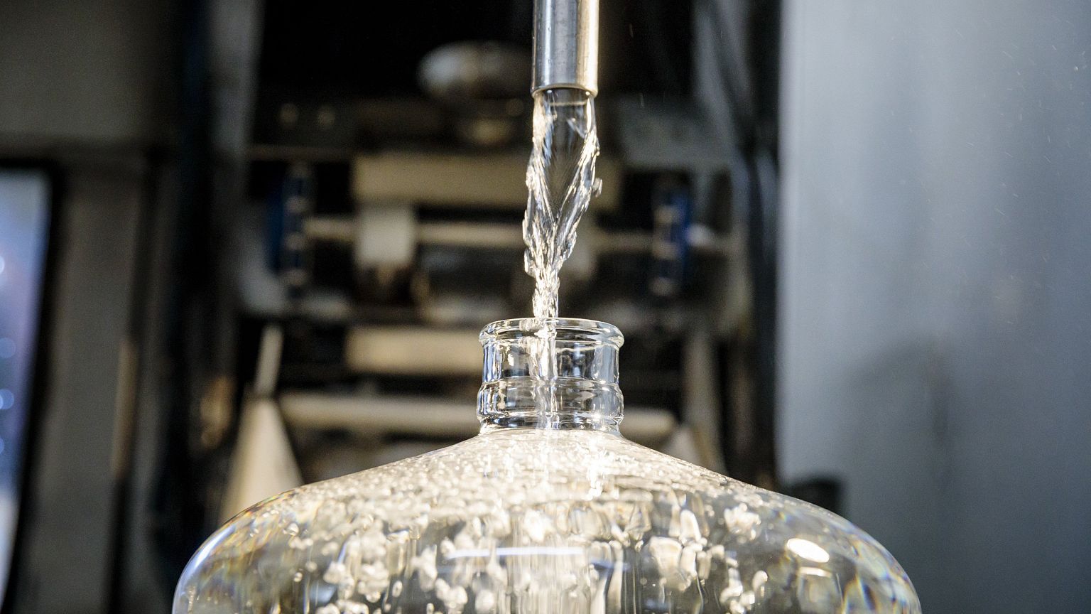 Image: Unfiltered, untreated, unsterilized spring water flows into a bottle