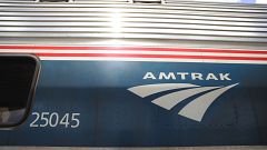 Image: An Amtrak train waits at a station