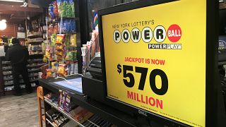 Image: A Powerball sign is pictured in a store in New York City