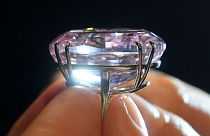A model poses with a 59.60-carat mixed cut diamond known as "The Pink Star"