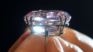 A model poses with a 59.60-carat mixed cut diamond known as "The Pink Star"