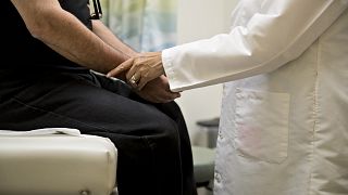 Image: A doctor examines a patient