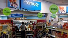 Image:  A customer waits at the counter of a CVS Pharmacy store in Pasadena
