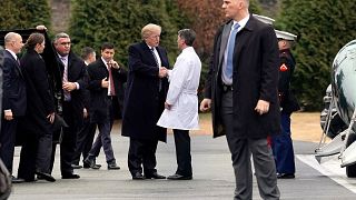 Image: U.S. President Donald Trump shakes hands with Dr. Ronny Jackson afte
