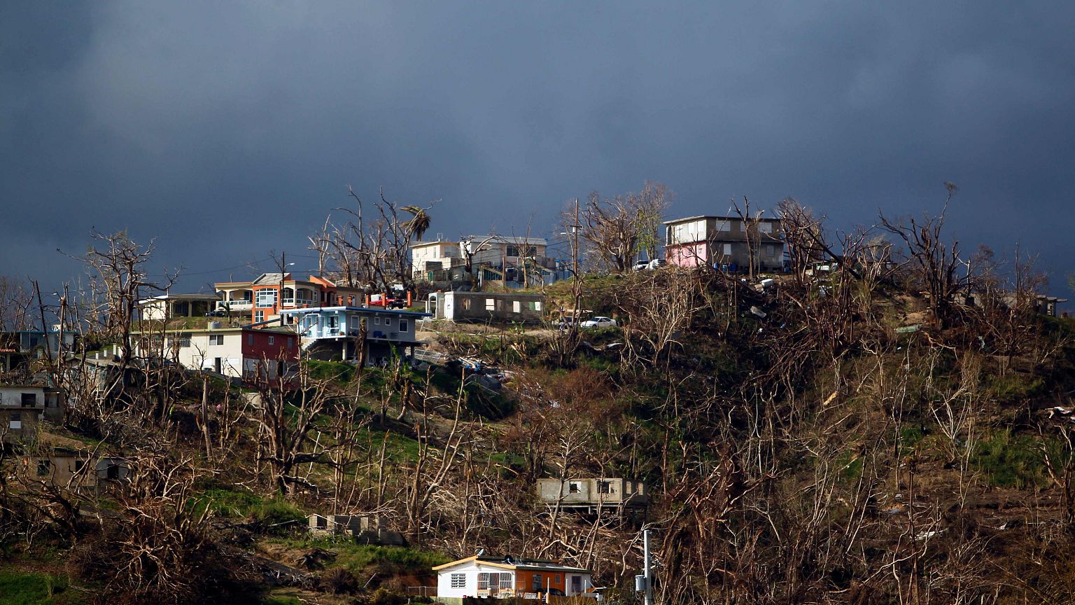 Image: Damaged houses are seen on top of a hill in Yabucoa, Puerto Rico