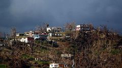 Image: Damaged houses are seen on top of a hill in Yabucoa, Puerto Rico