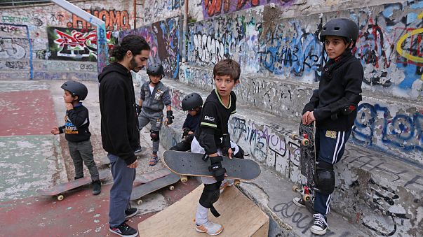 A group of young Syrian and Afghan refugees during a skateboarding lesson offered by the Free Movement Skateboarding in Athens.
