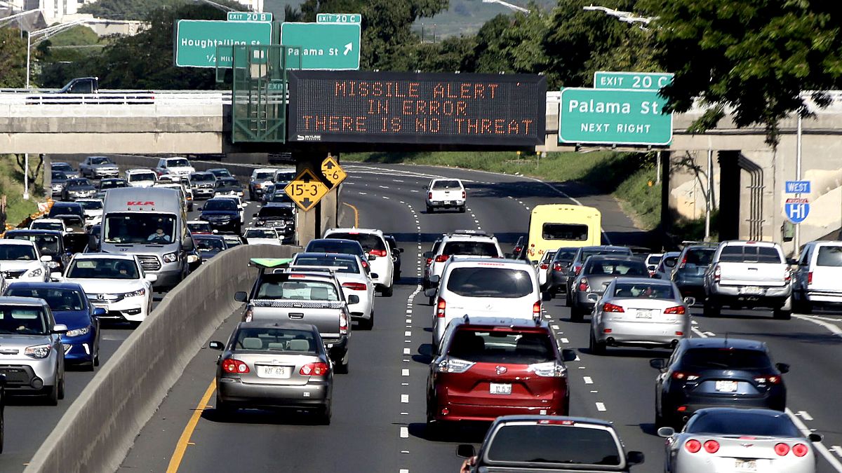 Image: Electronic signs displaying the emergency missile alert being fake i