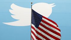 Image: The Twitter Inc. logo is shown with the U.S. flag during the company