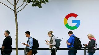 Image: People wait in line to enter a Google product launch