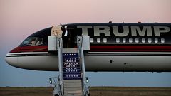 Image: Trump waves as he walks off his plane at a campaign rally in Colorad