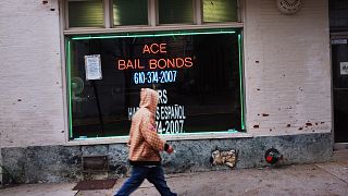 Image: A man walks by a bail bonds store on Oct. 20, 2011 in Reading, Penns