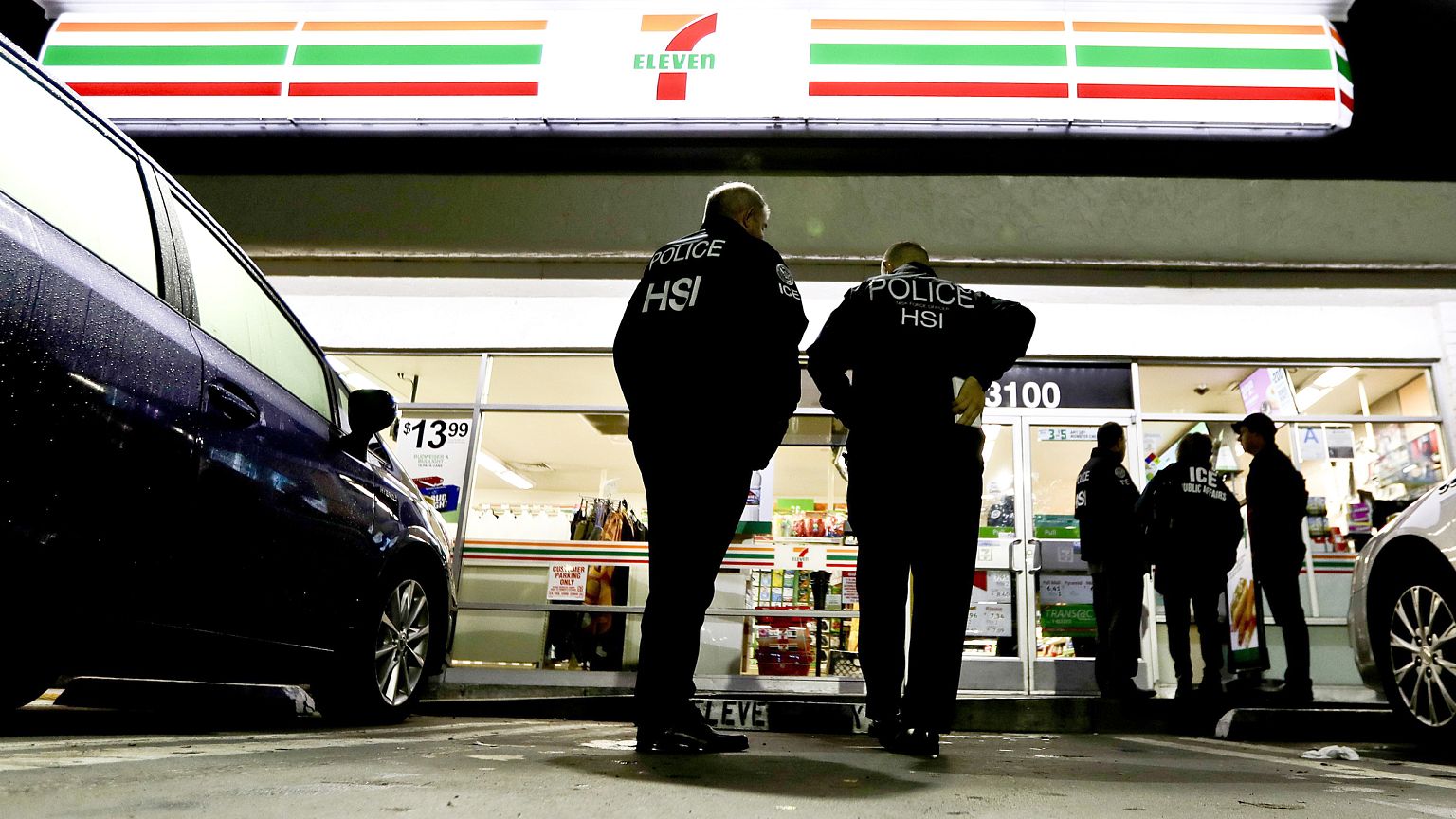 Image: U.S. Immigration and Customs Enforcement agents serve an employment 