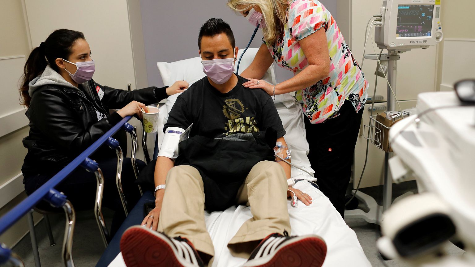 Image: Emergency room nurse Christine Bauer treats Joshua Lagade of Vista, 