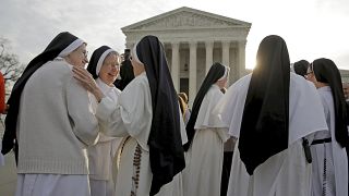 Image: Nuns speak to each other before Zubik v. Burwell is heard by the U.S