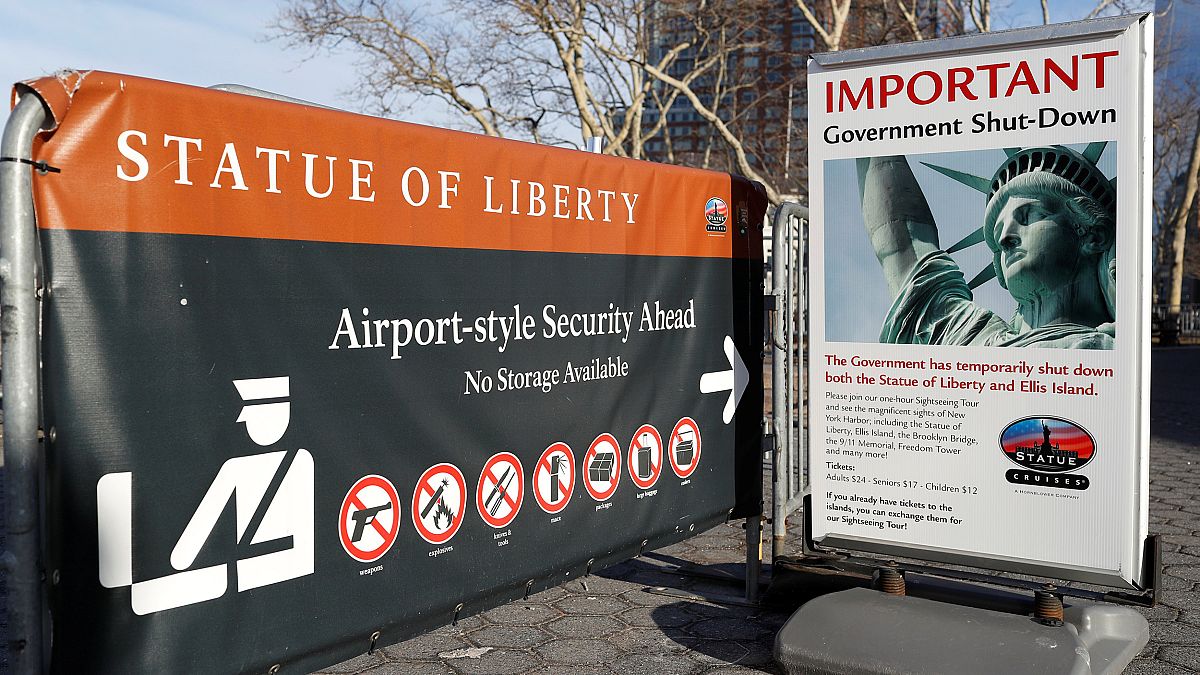 Image: A sign announcing the closure of the Statue of Liberty, due to the U