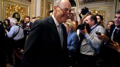 Image: Senate Minority Leader Chuck Schumer (D-NY) walks from a Democratic 