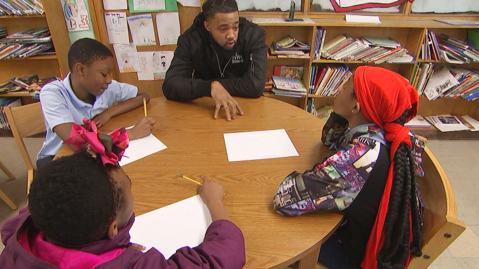 Image: Aaron Maybin speaks to students at Matthew A. Henson Elementary Scho