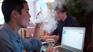 Image: E-cigarette smoker exhales vapor