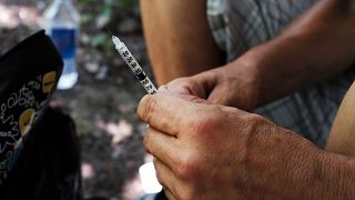 Image: Mike, a heroin addict who wants to get help, prepares to inject hims