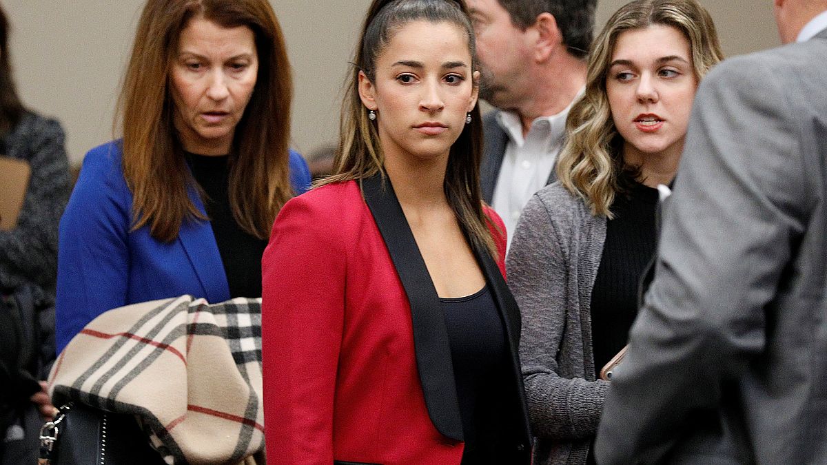 Image: Victim and former gymnast Aly Raisman appears before speaking at the