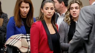 Image: Victim and former gymnast Aly Raisman appears before speaking at the