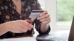 Image: Woman Cutting Credit Card with Scissors