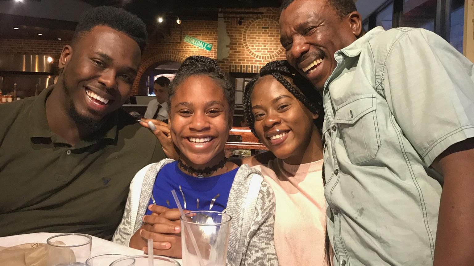 Image: Errol Wray Jr. (left) with his two younger sisters and his dad Errol