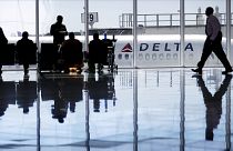 Image: A Delta Air Lines jet sits at a gate at Hartsfield-Jackson Atlanta I