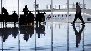 Image: A Delta Air Lines jet sits at a gate at Hartsfield-Jackson Atlanta I