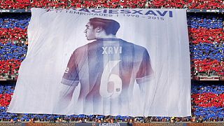 Barca fans pay tribute to club legend Xavi