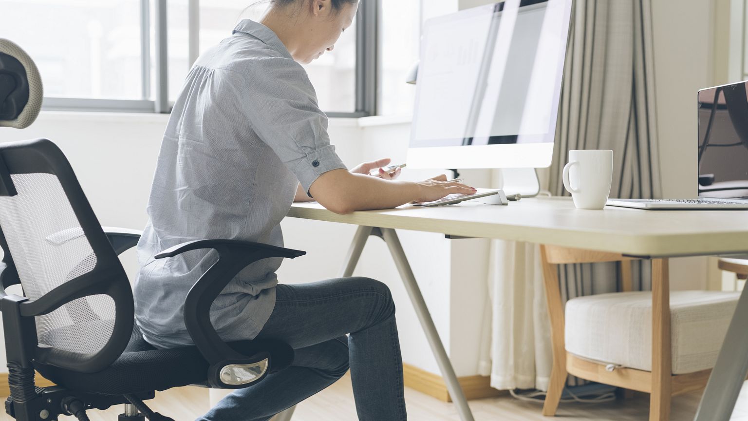 Image: A woman works from home