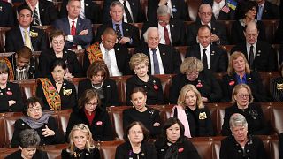 Image: Democratic members of congress listen as U.S. President Trump delive