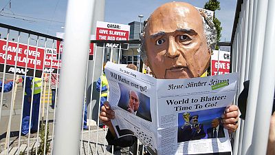 Protesters demand the resignation of FIFA's Blatter