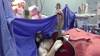 Watch: Brave Beatles fan plays guitar during brain surgery