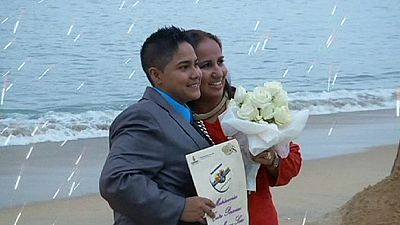 Gay couple hold mass beach wedding