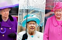 Queen Elizabeth II with umbrellas