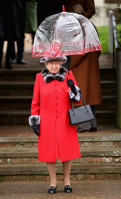 Queen Elizabeth II is a lady in rainy-day red attending a Christmas service in 2015. 