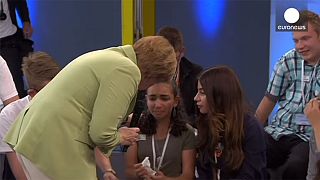 #Merkelstrokes: the German Chancellor is confronted by a crying refugee