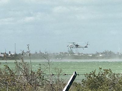 A helicopter circles near the area of a downed Navy fighter jet near Key West, Florida, on Wednesday.