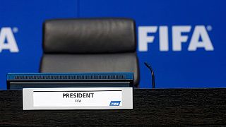 Sepp Blatter suspends press conference after being showered with fake dollars