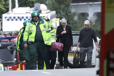 An injured woman is led away from Parsons Green subway station in London on Sept. 15.