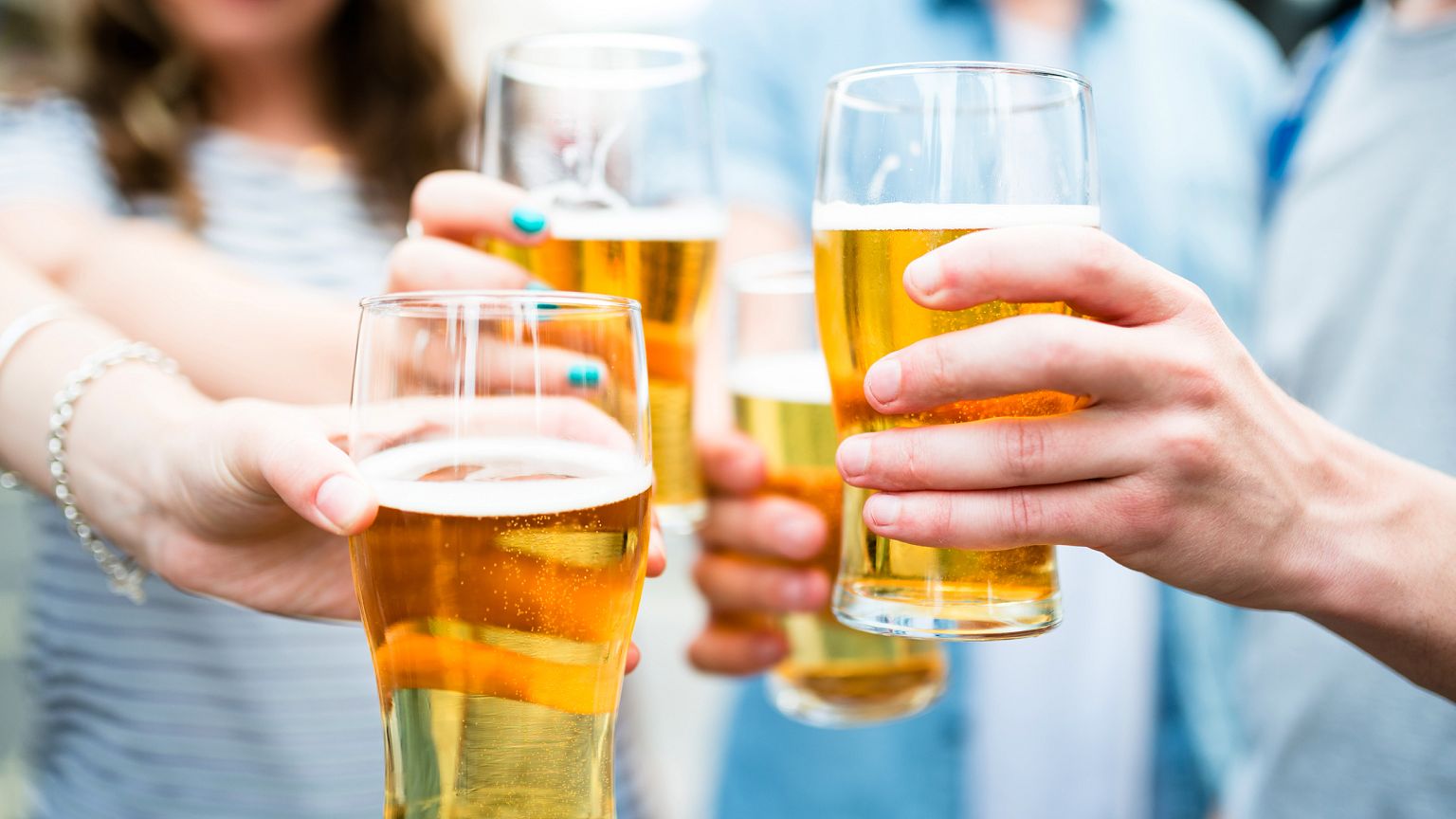 Image: Friends drink pints of beer at Oktoberfest